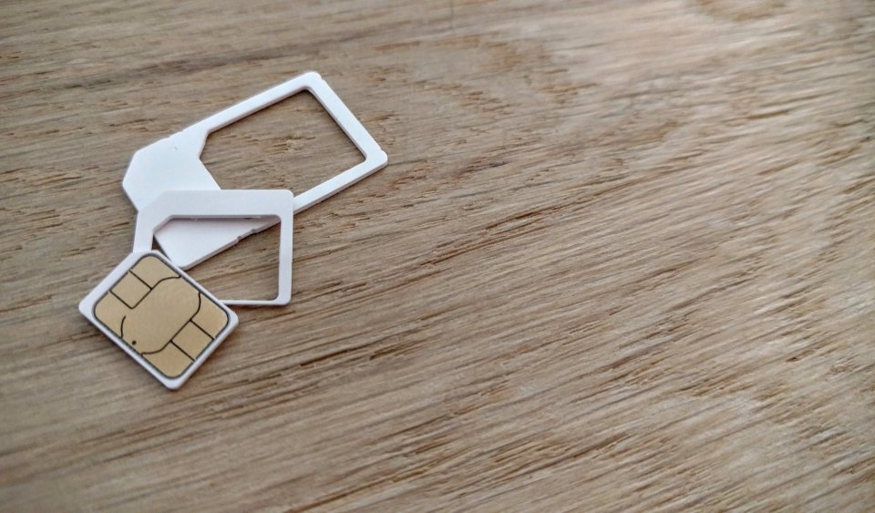 Sim card and adapters on a wooden table